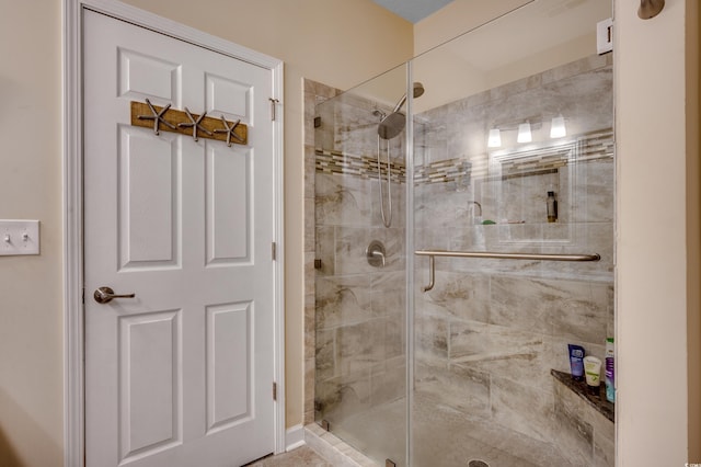 bathroom with a shower with shower door