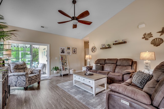 living room featuring vaulted ceiling, dark wood-type flooring, and ceiling fan