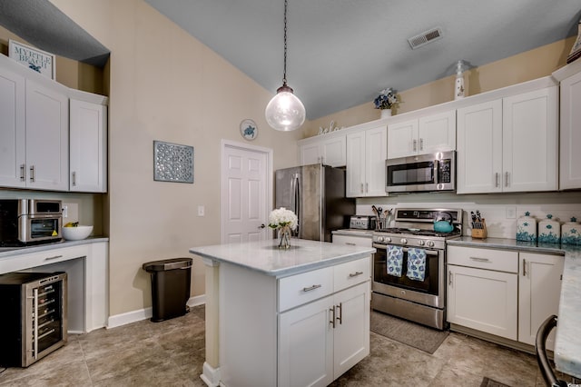 kitchen featuring wine cooler, white cabinetry, appliances with stainless steel finishes, and hanging light fixtures