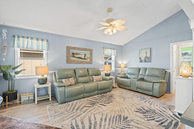 living room featuring light wood-type flooring, vaulted ceiling, a wealth of natural light, and ceiling fan