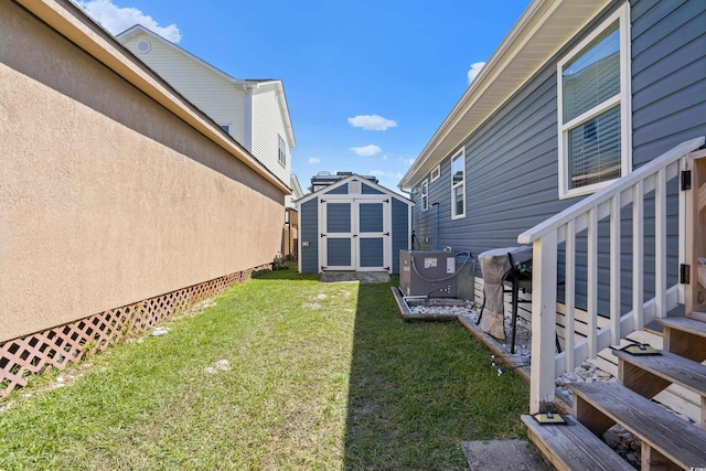 view of yard with a shed and central AC