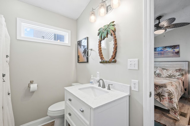 bathroom featuring vanity, toilet, and ceiling fan