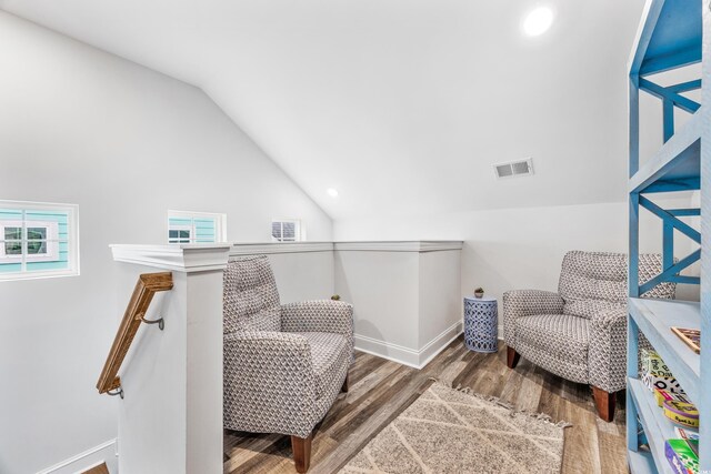 sitting room featuring hardwood / wood-style flooring and lofted ceiling