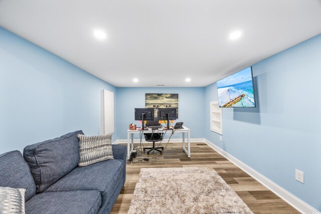 home office with hardwood / wood-style flooring