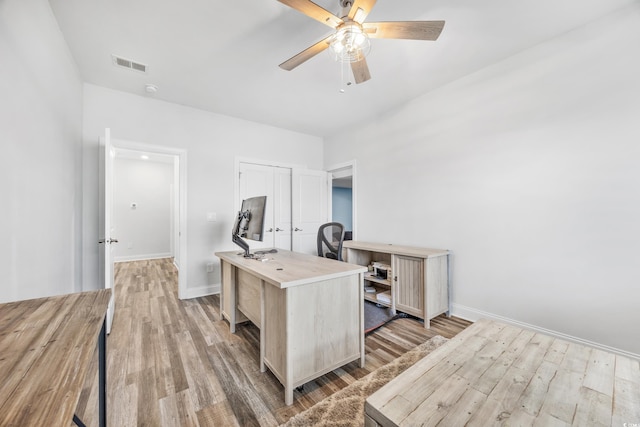 office area with ceiling fan and light hardwood / wood-style flooring