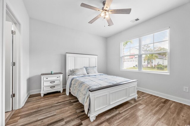 bedroom with ceiling fan and hardwood / wood-style flooring