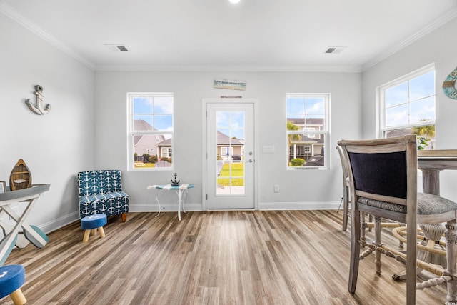 doorway featuring wood-type flooring and ornamental molding