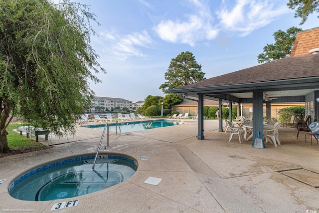 view of pool with a community hot tub and a patio area