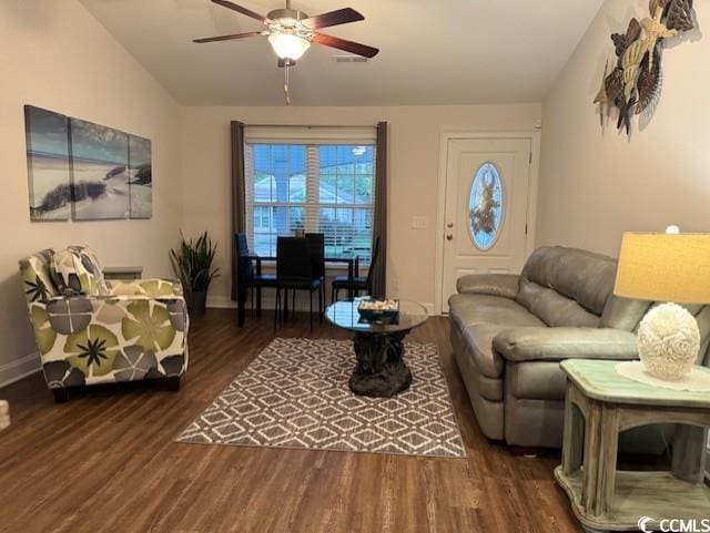 living room featuring dark hardwood / wood-style flooring, vaulted ceiling, and ceiling fan