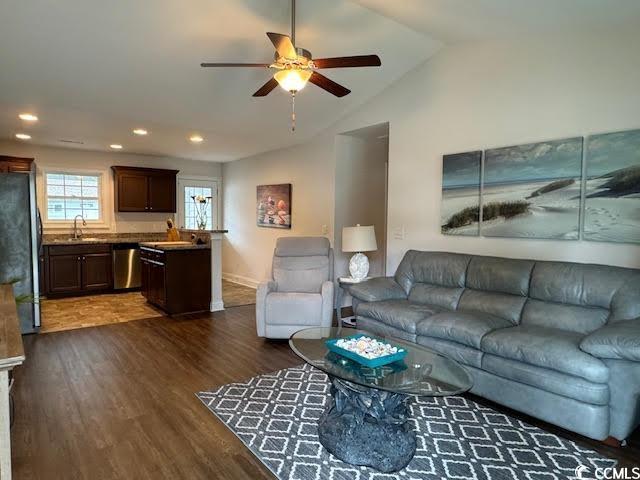 living room with lofted ceiling, sink, ceiling fan, and dark hardwood / wood-style floors