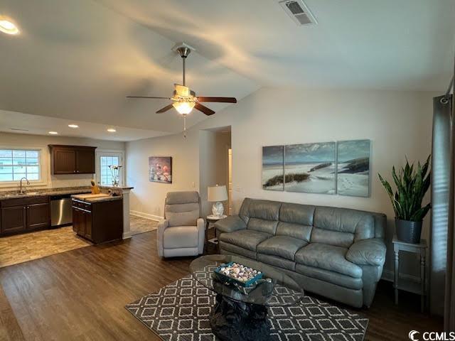 living room with lofted ceiling, ceiling fan, dark wood-type flooring, and sink