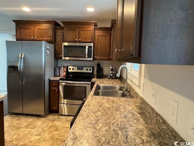 kitchen with sink and appliances with stainless steel finishes