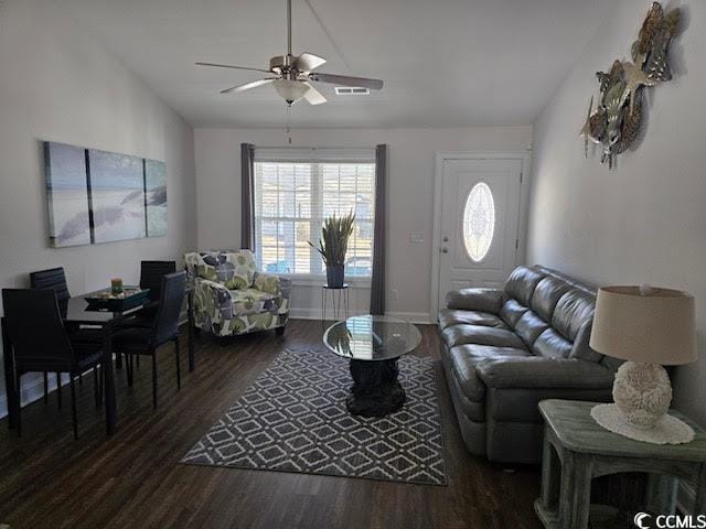 living room with dark hardwood / wood-style floors and ceiling fan