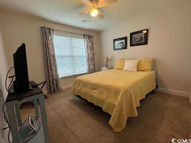 bedroom featuring dark colored carpet and ceiling fan