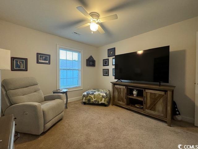 living room featuring carpet flooring and ceiling fan