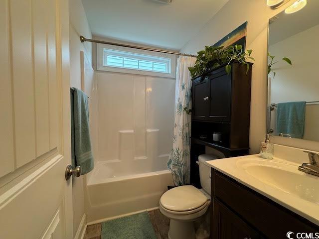 full bathroom with vanity, toilet, and shower / bath combo with shower curtain