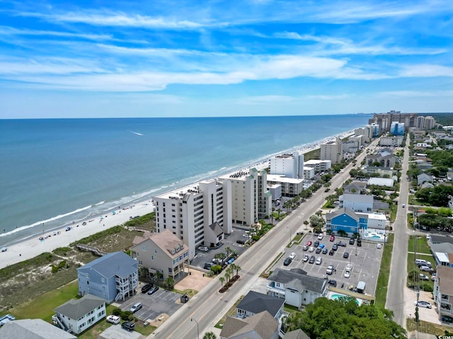 drone / aerial view featuring a beach view and a water view