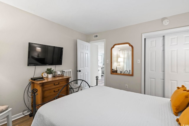 bedroom featuring wood-type flooring and a closet