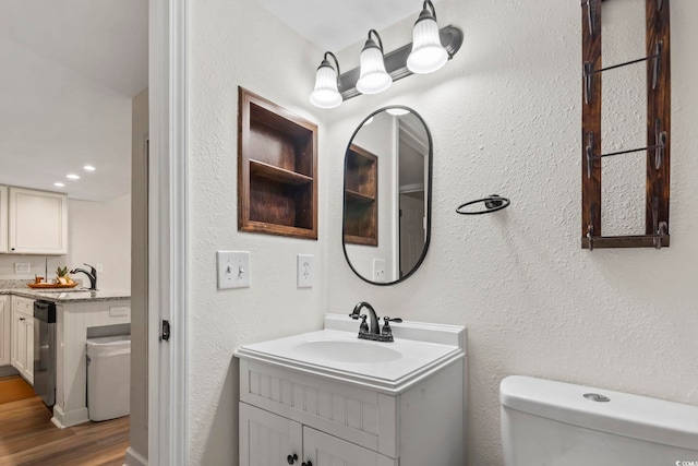 bathroom with vanity, hardwood / wood-style floors, and toilet