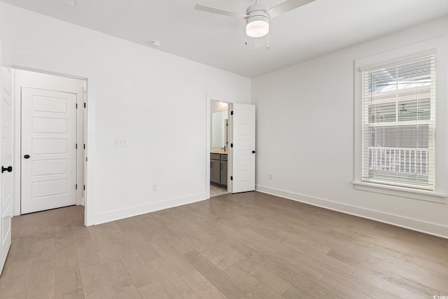 unfurnished bedroom with ceiling fan, light wood-type flooring, and ensuite bathroom