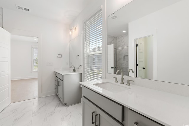 bathroom with vanity and a shower with door