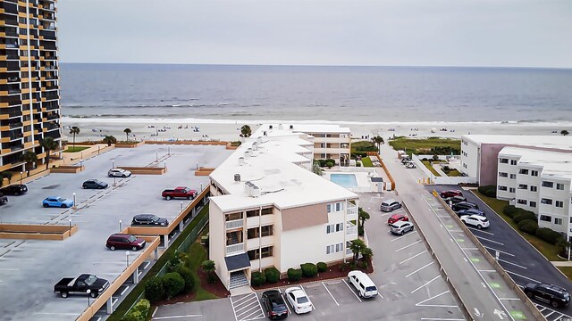 bird's eye view featuring a water view and a view of the beach