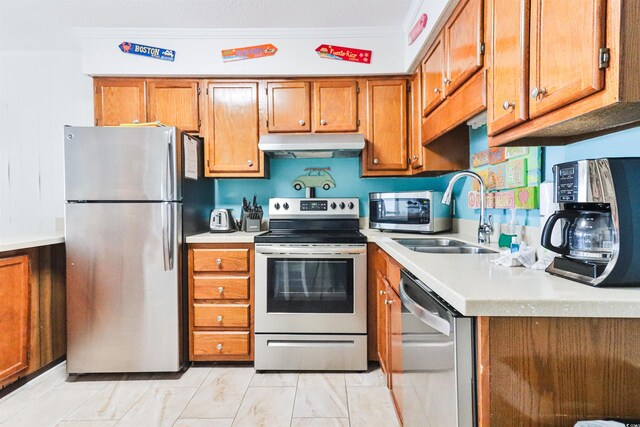 kitchen with appliances with stainless steel finishes, crown molding, and sink