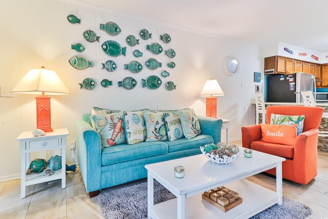 tiled living room featuring crown molding