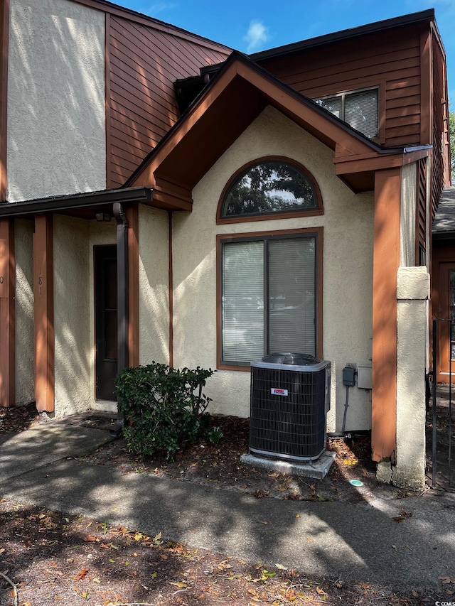 entrance to property featuring cooling unit