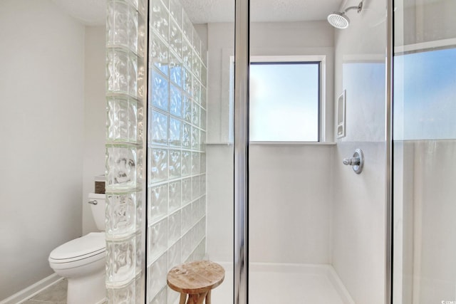 bathroom featuring tile patterned flooring, a textured ceiling, walk in shower, and toilet