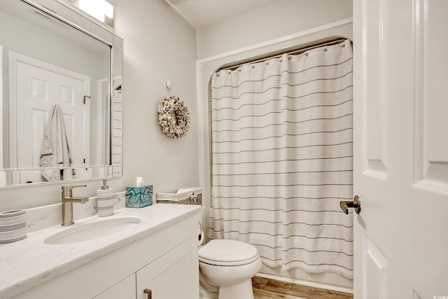 full bathroom featuring wood-type flooring, shower / bath combination with curtain, vanity, and toilet