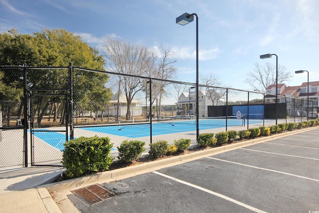 view of swimming pool with tennis court