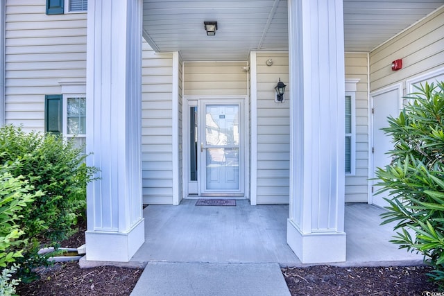 doorway to property featuring covered porch