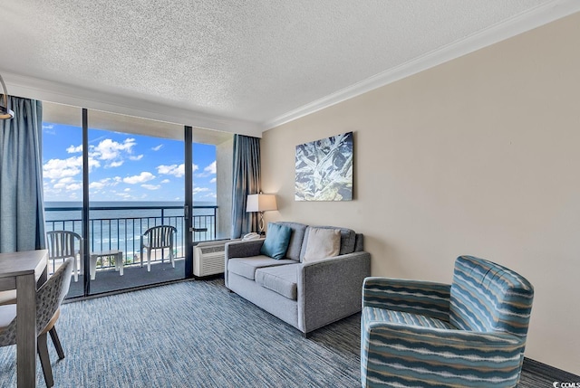 carpeted living room with a textured ceiling, a wall of windows, crown molding, and a water view