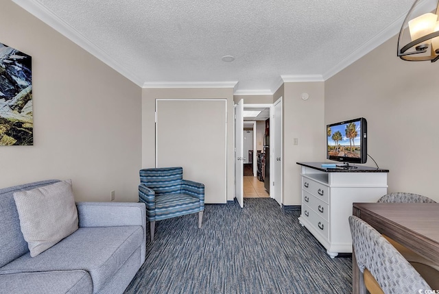 sitting room with ornamental molding, a textured ceiling, and dark carpet