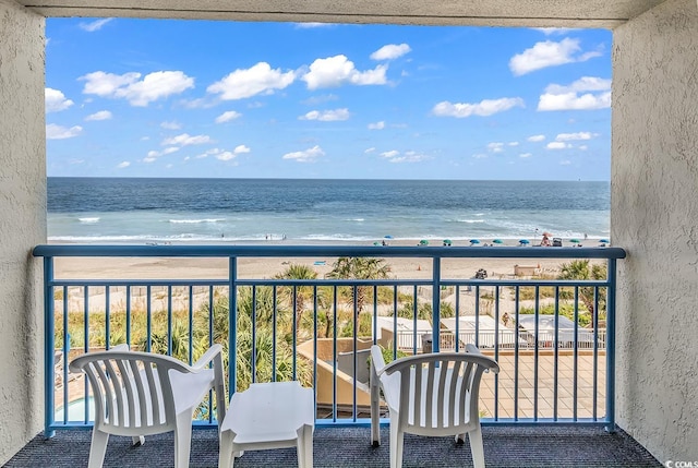 balcony with a view of the beach and a water view