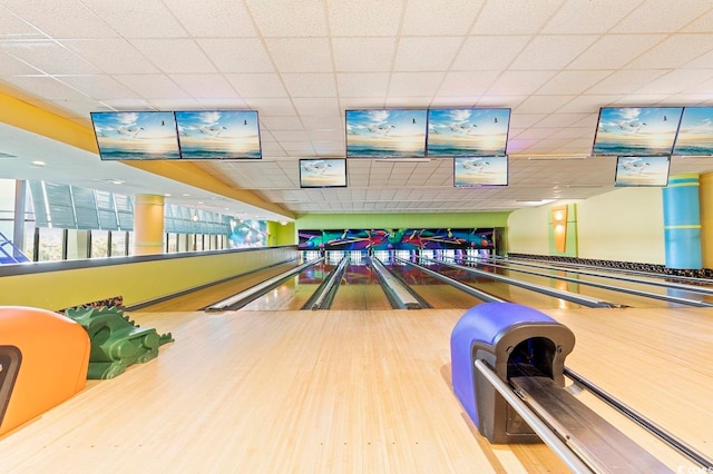 playroom featuring a paneled ceiling, bowling, and hardwood / wood-style flooring