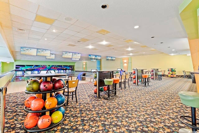 recreation room with carpet flooring and a paneled ceiling