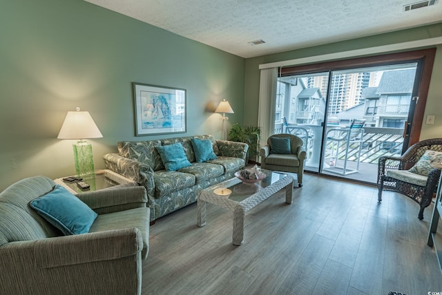 living room featuring a textured ceiling and hardwood / wood-style floors