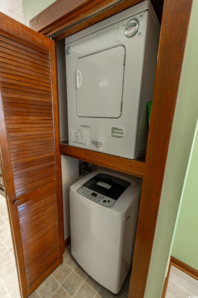 washroom featuring stacked washer and dryer