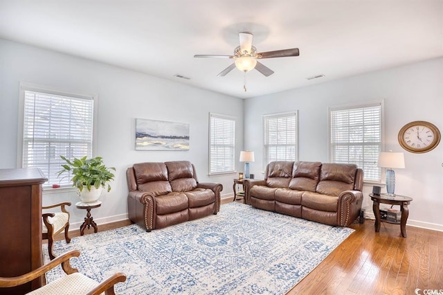 living room featuring ceiling fan and light hardwood / wood-style floors