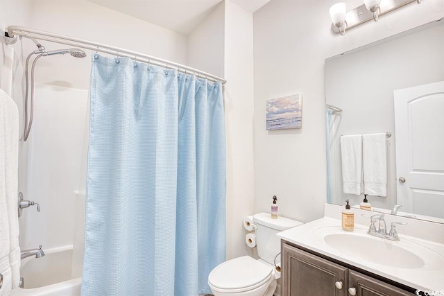 full bathroom with vanity, shower / tub combo, and toilet