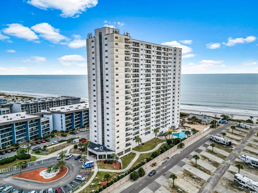 exterior space featuring a water view and a beach view