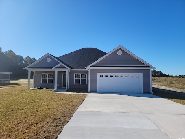 view of front of home with a garage and a front lawn