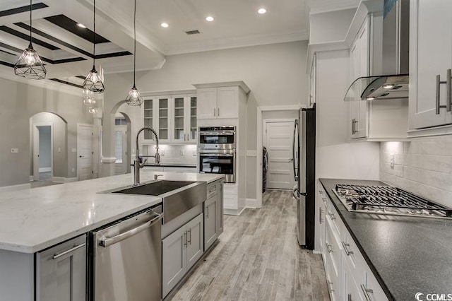 1104 Maccoa Dr, Conway, SC 29526 - kitchen featuring a sink, wall chimney exhaust hood, stainless steel appliances, arched walkways, and ornamental molding