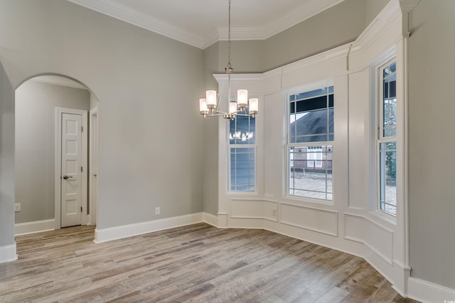 1104 Maccoa Dr, Conway, SC 29526 - unfurnished dining area featuring an inviting chandelier, light wood-style flooring, crown molding, baseboards, and arched walkways