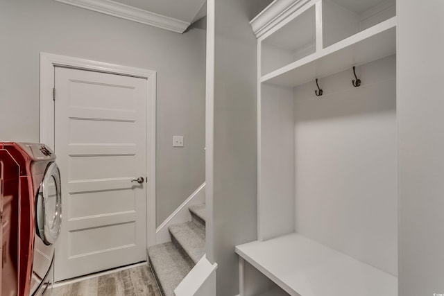 mudroom with ornamental molding, light hardwood / wood-style floors, and washing machine and dryer