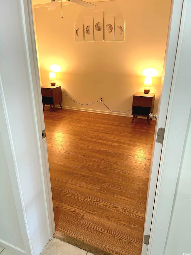 hallway with hardwood / wood-style flooring