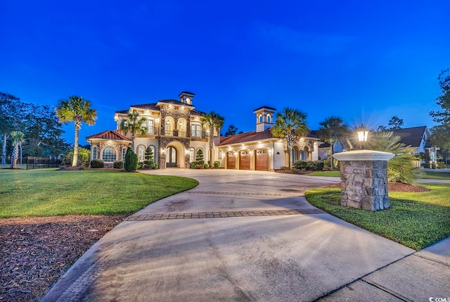 mediterranean / spanish home with a lawn, a balcony, and a garage