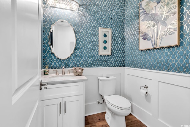 bathroom featuring vanity, toilet, and hardwood / wood-style flooring